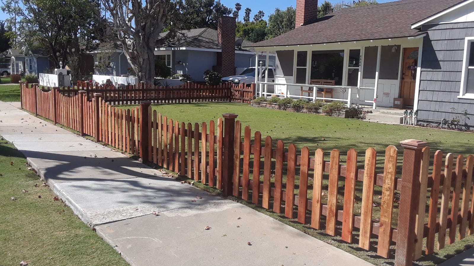 A wooden fence stands in front of a house in Anaheim, California,