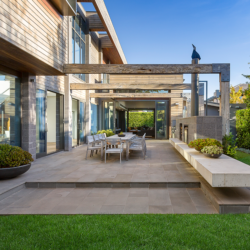 back patio with simple pergola and large outdoor table for dining