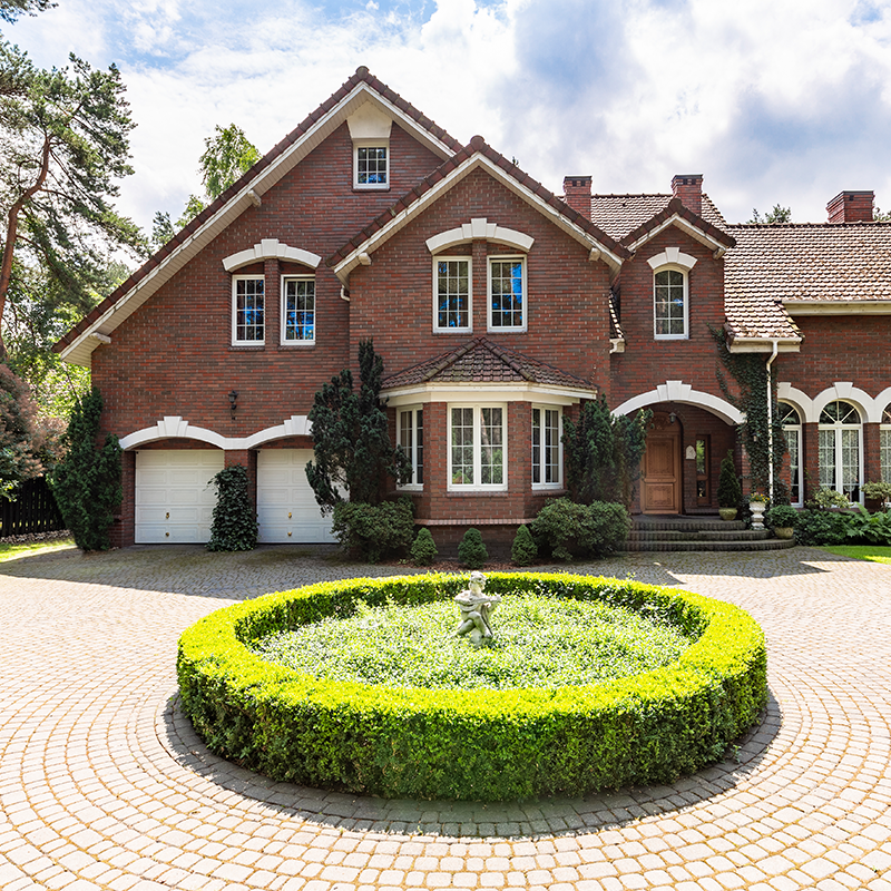 red brick home with a circle drive